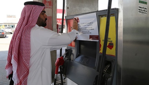 An inspector putting up the closure notice at the fuel station