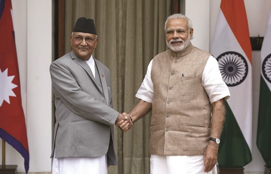 Nepalu2019s Prime Minister Khadga Prasad Sharma Oli, left, shaking hands with his Indian counterpart Narendra Modi during a photo opportunity ahead of their meeting at Hyderabad House in New Delhi yesterday.