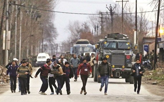 Residents run to safety after being rescued from a building taken over by suspected militants during clashes in the Sempora area of Pampore, some 15km south of Srinagar yesterday.