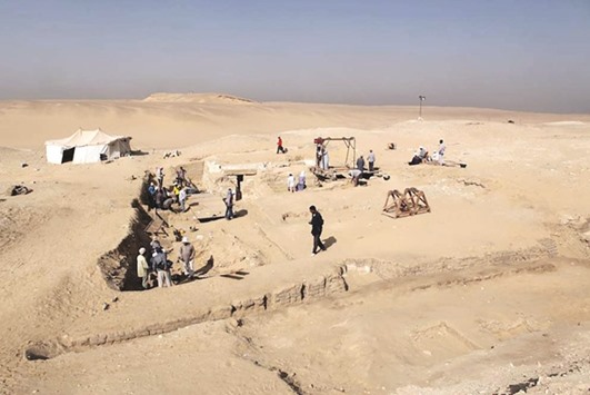 A handout picture released by the Egyptian antiquities ministry yesterday shows workers at the site where Czech archaeologists discovered the ancient funerary boat.