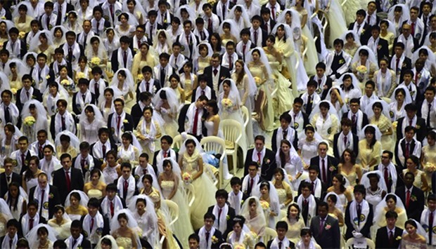 Couples attend a mass wedding in South Korea