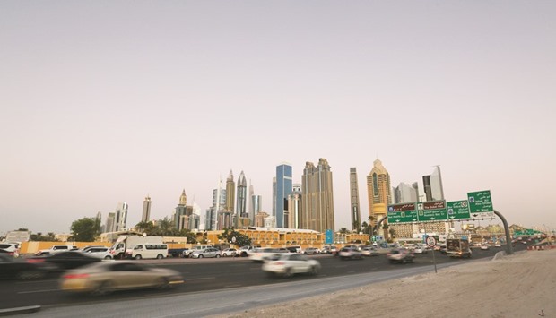 Traffic passes along a highway towards skyscrapers on the city skyline at dusk in Dubai. While the slump in oil prices is hurting demand from other Gulf countries, some wealthy Africans are seen buying in Dubai to park their cash in dollar-linked assets as currencies in their home countries decline.