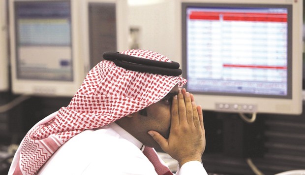 A Saudi trader monitors stocks at the Saudi Investment Bank in Riyadh. The Saudi stock index, which rose 3.9% last week, fell back 0.1% yesterday, though trading remained active. Saudi Basic Industries slipped 0.7%.