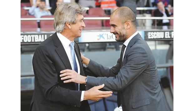 OVER TO YOU: Outgoing Man City manager Manuel Pellegrini (left) with his successor Pep Guardiola