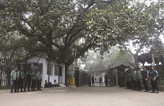 Police stand guard at the war crimes court where the two criminals were sentenced in Dhaka yesterday.