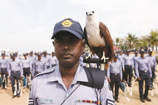 An eagle, the symbol of Sri Lankau2019s Air Force, stands on a soldieru2019s shoulder at a parade during a rehearsal for Sri Lankau2019s 68th Independence Day celebrations in Colombo, yesterday.