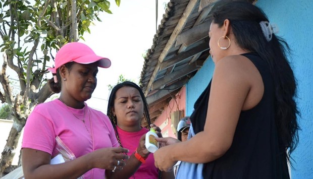 Health workers hand out mosquito repellent to a pregnant woman during a campaign to fight the spread of Zika virus in Soledad municipality near Barranquilla, Colombia.