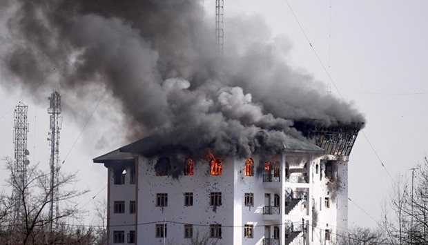 Smoke billows from a building during a gunbattle on the outskirts of Srinagar on Monday.
