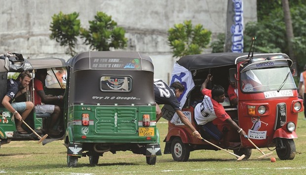 Players take part in a tuk-tuk (three-wheeler) polo match as part of a promotional event organised by a local Sri Lankan leasing company in the southern town of Galle.