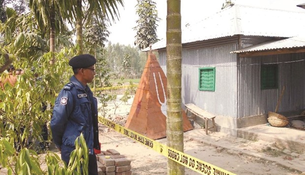 A policeman stands guard where a top Hindu priest was killed in Panchagarh district, some 400km north of Dhaka,on February 21.