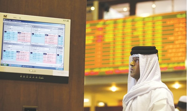 A Gulf investor follows the stock market developments on a monitor screen at the Dubai Financial Market (file). Dubaiu2019s benchmark jumped 2.5% yesterday in the heaviest volume since June 2015.