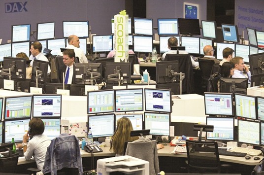 Brokers working at the Frankfurt Stock Exchange. The DAX 30 closed 1.98% up at 9,573.59 points yesterday.
