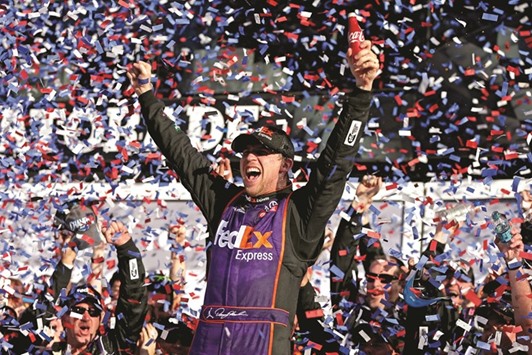 NASCAR Sprint Cup Series driver Denny Hamlin celebrates winning the Daytona 500 at Daytona International Speedway.