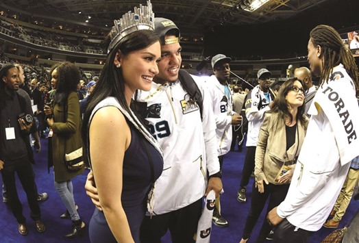 Pia Wurtzbach, the 2015 Miss Universe, poses for a photo with Carolina Panthers free safety Dean Marlowe (29) during Super Bowl 50 Opening Night media day at SAP Center on Monday.