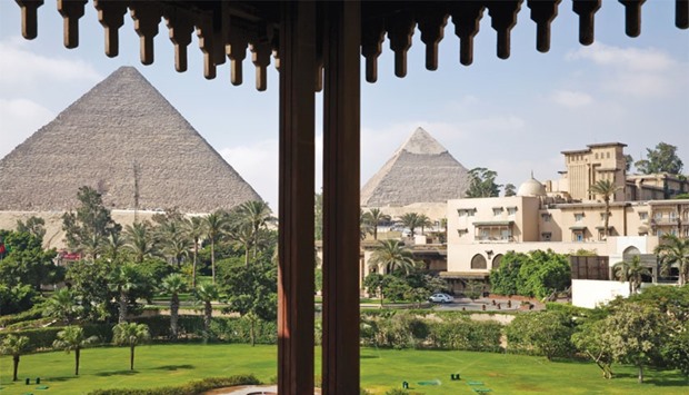 The ancient pyramids of Giza stand beyond the gardens of the Mena House hotel in Cairo. Tourism generated $7.3bn for Egypt in the fiscal year ending June 30, equivalent to the value of about 12% of the countryu2019s imports of goods. That compares with a record high of $12.5bn in 2010.