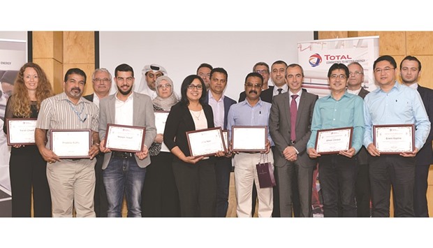 Employees during a ceremony held at the Total Research Centre at Qatar.