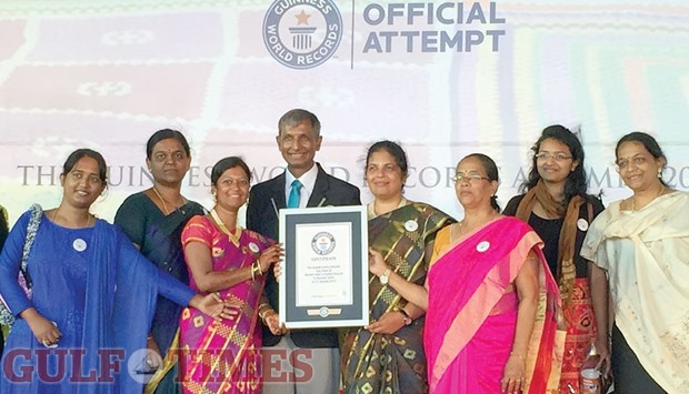 MICQ women posing with the certificate and adjudicator Pravin Patel.