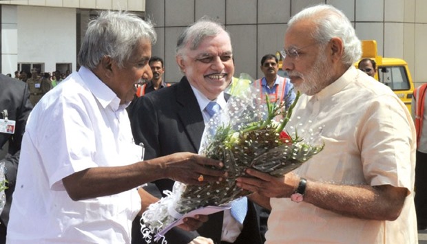 Prime Minister Narendra Modi is welcomed by Kerala Governor P Sathasivam and Chief Minister Oommen Chandy at Kozhikode Airport yesterday.