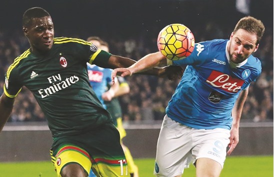 Napoli forward Gonzalo Higuain (R) fights for the ball with AC Milan defender Cristian Zapata during the Italian Serie A match at the San Paolo stadium in Naples.