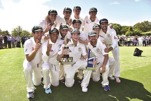 Australian captain Steve Smith holds the Trans Tasman trophy with his teammates after winning the 2nd Test against New Zealand at the Hagley Park in Christchurch yesterday. (AFP)