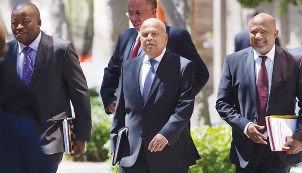 South Africau2019s Minister of Finance Pravin Gordhan(right) walks to Parliament in Cape Town yesterday.