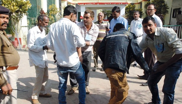 Officials frisk students before they were allowed to enter an examination centre in Patna yesterday.