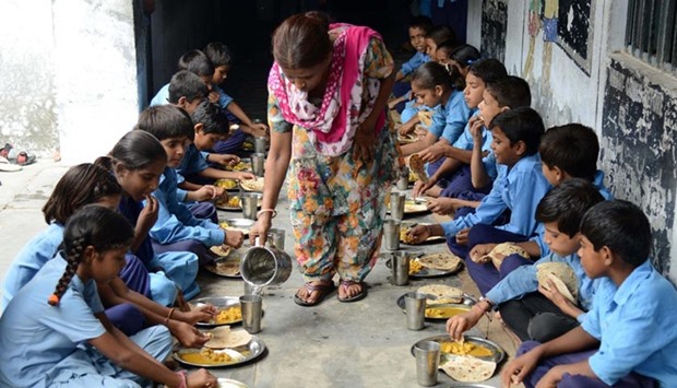 Indian schoolchildren eat a free midday meal at a government school in Amritsar in this file picture taken on July 19, 2013.