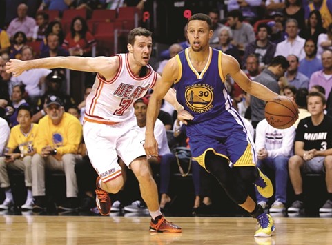 Stephen Curry (#30) of Golden State Warriors drives past Goran Dragic of Miami Heat during their NBA game in Miami, Florida, on Wednesday. (AFP)