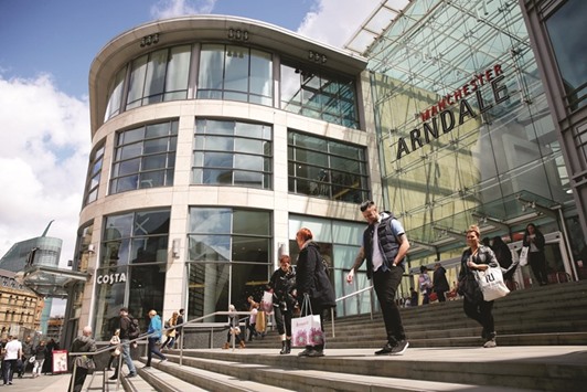 Shoppers exit the entrance to the Manchester Arndale shopping centre. The UKu2019s household consumption rose 0.7% between October and December, helping to counter a second quarter of declining exports and the biggest drop in business investment in almost two years, the Office for National Statistics said yesterday.