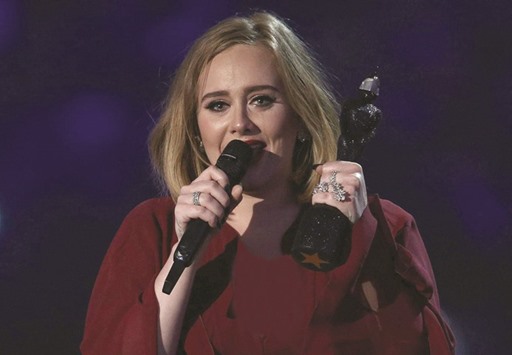 Tears run down the face of singer Adele as she reacts after receiving the Global Success award during the Brit Awards 2016 in London.