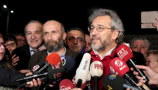 Can Dundar, editor-in-chief of Cumhuriyet (right), accompanied by his Ankara bureau chief Erdem Gul, speaks to the media outside the Silivri prison complex near Istanbul on Friday.