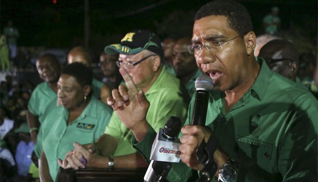 Andrew Holness (R), leader of the opposition Jamaican Labour Party, speaks to supporters at the party headquarters after they won the general election in Kingston, Jamaica