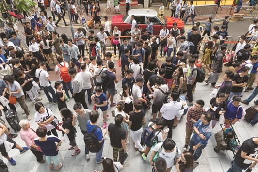 People resell iPhone smartphones outside Appleu2019s Causeway Bay store in Hong Kong. While global brands including HP, Huawei, Amazon and Microsoft also have detailed protocols for recycling their products, Appleu2019s are the most rigid and exacting, according to people involved in the processes.