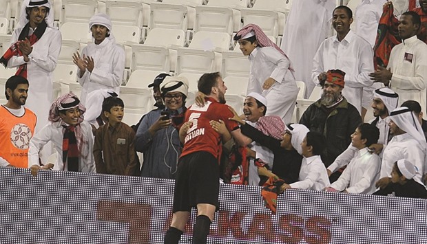 Al Rayyanu2019s Nathan gets into celebratory mode with his team fans at the Al Sadd Club yesterday.