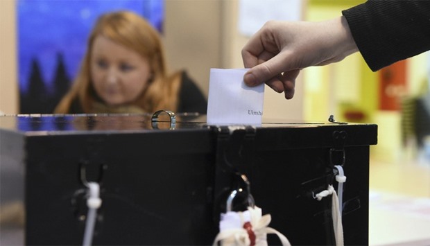A woman casts her vote in a polling station in Castlebar, Ireland