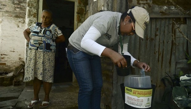 A researcher checks mosquito traps in the Paris neighborhood, Bello municipality, Antioquia department, Colombia
