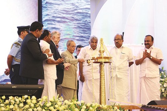 President Pranab Mukherjee lights the traditional lamp at the launch of Kerala Tourismu2019s Muziris Heritage Project as (from left) state chief secretary Jiji Thomson, MLA T N Prathapan, Governor Justice P Sathasivam, Chief Minister Oommen Chandy, MP K V Thomas and MLA V D Satheesan look on.
