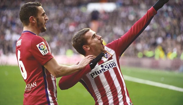 Atletico Madridu2019s Antoine Griezmann (right) celebrates with team-mate Koke after scoring against Real Madrid at the Santiago Bernabeu stadium in Madrid yesterday. (AFP)