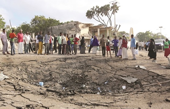 Residents gather at the scene of a car bomb attack near Somali Youth League Hotel in Mogadishu.