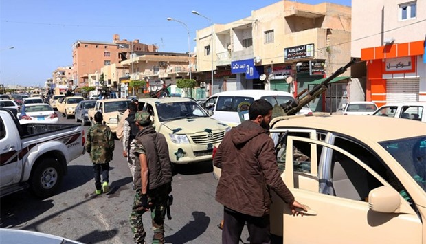 Militia fighters man a checkpoint in the Libyan city of Sabratha yesterday. The city west of the capital had been the scene of fierce fighting earlier this week between IS and forces loyal to the Tripoli administration.