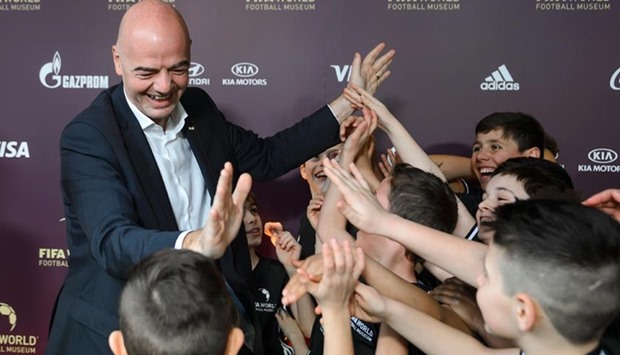 FIFA's new president Gianni Infantino gives children from a football school high fives during the inauguration of the FIFA World Football Museum in Zurich on Sunday.