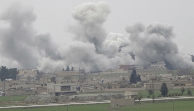 Smoke rises over the northern Syrian town of Tel Abyad