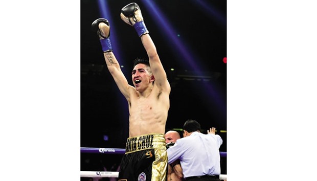 Leo Santa Cruz celebrates his fifth round TKO of Kiko Martinez that helped him retain his Featherweight Super title. (AFP)