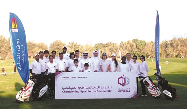 Qatar Golf Association officials pose for a photo with junior golfers at the Doha Golf Club.