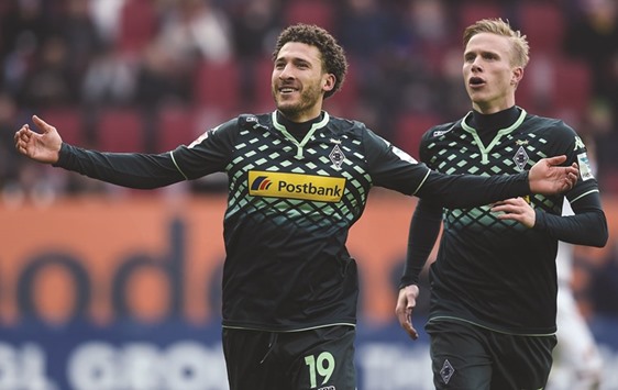 Moenchengladbachu2019s Fabian Johnson (L) and Oscar Wendt celebrate after the second goal against Augsburg yesterday.