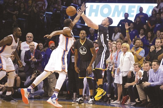 Golden State Warriors guard Stephen Curry (right) attempts a three-point shot against Oklahoma City Thunder forward Kevin Durant (35) during the fourth quarter at Chesapeake Energy Arena in Oklahoma City on Saturday. (USA TODAY Sports)