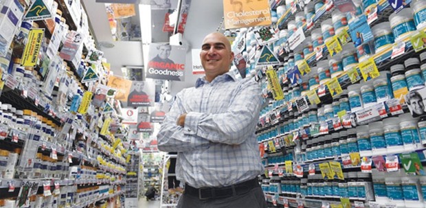 Peter Barraket, who heads up u2018Mr Vitaminsu2019, a chain of supplement outlets in Sydney, poses next to shelves packed with vitamins in his Chatswood outlet. Asian consumers determined to improve their lifestyle are boosting the fortunes of Australian producers of premium baby milk formula, vitamins and honey, as the regionu2019s burgeoning middle class jumps on the health food bandwagon.