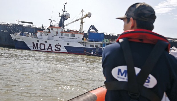 A Migrant Offshore Aid Station (MOAS) crew drives a boat to return to the MOAS ship, MV Phoenix, at the Chao Phraya river in Samut Prakan province, Thailand.