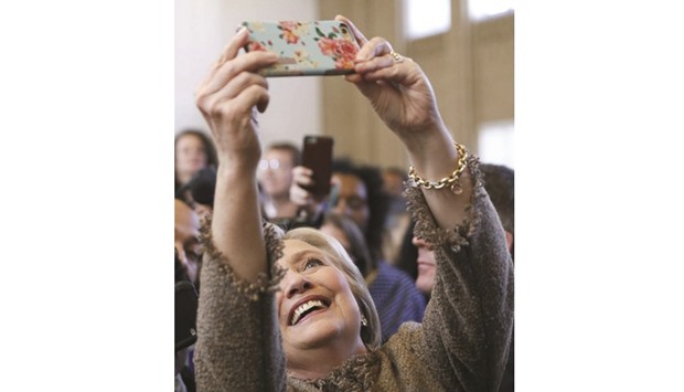 Democratic US presidential candidate Hillary Clinton takes selfies with people during a campaign stop at Atlanta City Hall on Friday.
