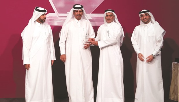 Ooredoo Qataru2019s chief operating officer Yousuf Abdulla al-Kubaisi receiving an award from Qatar Chamber vice-chairman Mohamed bin Ahmed bin Towar al-Kuwari as QSE chief executive Rashid bin Ali al-Mansoori and Listing Department director Abdul Aziz al-Emadi look on yesterday. PICTURES: Anas Khalid